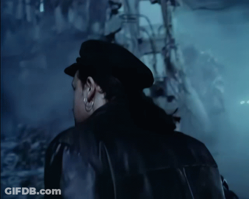 A Man Wearing A Black Hat And A Black Jacket GIF