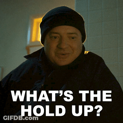 A Man Wearing A Black Hat And A Black Jacket Says What 'S The Hold Up GIF