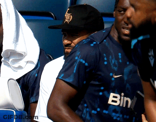 A Man Wearing A Black Hat And A Shirt That Says Bin GIF