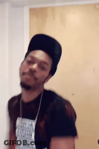 A Man Wearing A Black Hat And A T-Shirt That Says ' I 'M A Freak ' On It GIF