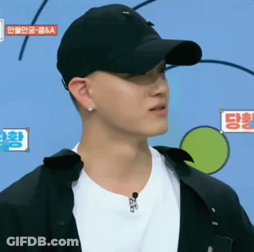 A Man Wearing A Black Hat And A White Shirt Has A Sign Above His Head That Says ' A & A ' GIF