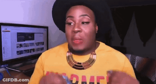 A Man Wearing A Black Hat And A Yellow Shirt With The Word Peace On The Front GIF