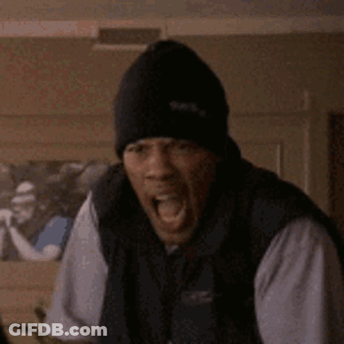 A Man Wearing A Black Hat Is Making A Funny Face . GIF