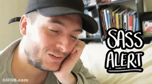 A Man Wearing A Black Hat Is Talking On A Cell Phone With Sass Alert Written On The Bottom GIF