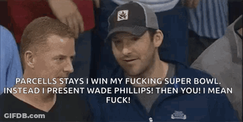 A Man Wearing A Black Hat Is Talking To Another Man GIF