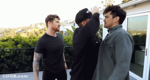 A Man Wearing A Black Hat That Says ' Balmain ' On It GIF