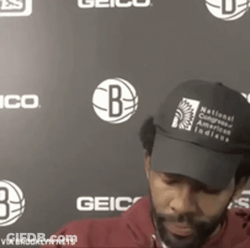 A Man Wearing A Black Hat That Says National Congress Of American Indians On It GIF