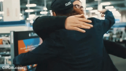 A Man Wearing A Black Hat That Says Place On It GIF