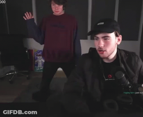 A Man Wearing A Black Hat That Says ' X-Men ' On It GIF
