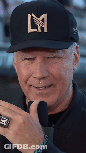 A Man Wearing A Black Hat With La Written On It GIF