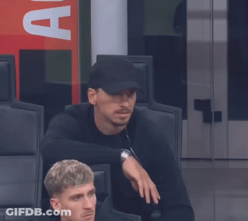 A Man Wearing A Black Hat With The Letter A On The Back GIF