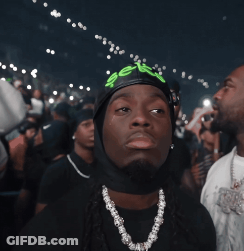 A Man Wearing A Black Hat With The Word Sex Written On It GIF