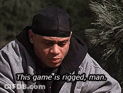 A Man Wearing A Black Headband And A Gray Jacket Is Saying This Game Is Rigged , Man . GIF