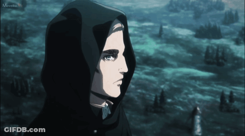 A Man Wearing A Black Hooded Cape Is Looking At Something In The Distance GIF