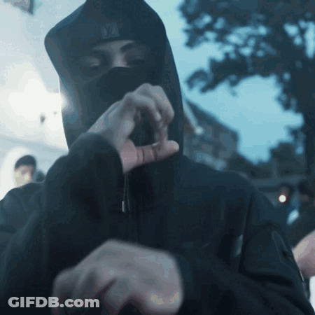 A Man Wearing A Black Hooded Jacket And A Ny Hat GIF