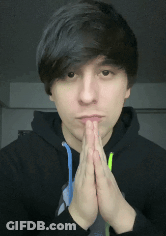 A Man Wearing A Black Hoodie Is Praying With His Hands Folded GIF
