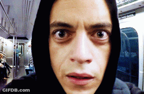 A Man Wearing A Black Hoodie Is Taking A Selfie On A Subway GIF