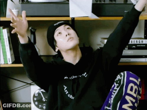 A Man Wearing A Black Hoodie That Says " Art Chic " On It GIF