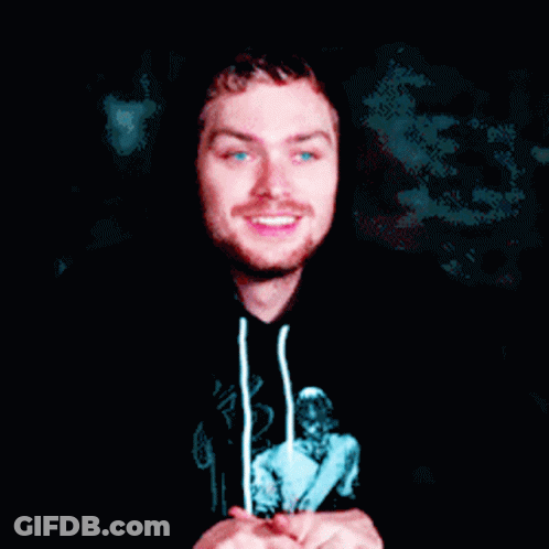 A Man Wearing A Black Hoodie With A Picture Of A Woman On It Is Smiling GIF