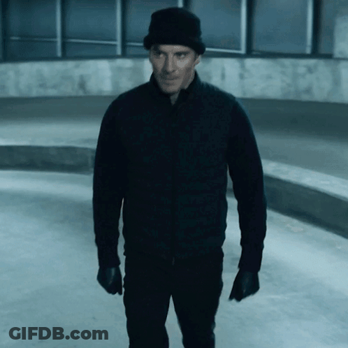 A Man Wearing A Black Jacket And A Black Hat GIF