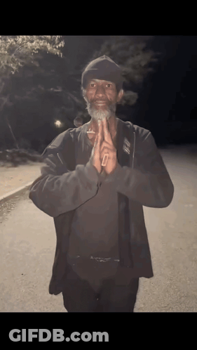 A Man Wearing A Black Jacket And A Hat With The Letter O On It GIF