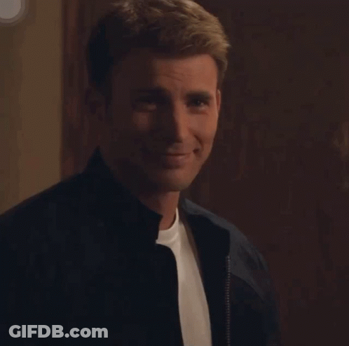 A Man Wearing A Black Jacket And A White Shirt Is Smiling GIF