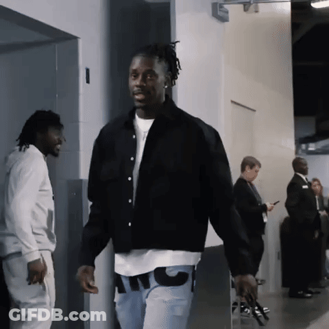 A Man Wearing A Black Jacket And A White T-Shirt That Says Atc GIF