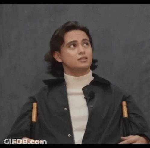 A Man Wearing A Black Jacket And A White Turtleneck Looks Up At The Sky GIF