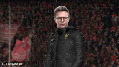 A Man Wearing A Black Jacket With A New Balance Logo On The Front GIF