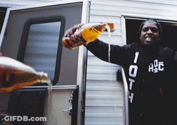A Man Wearing A Black Jacket With The Number 10 On It Pours A Drink From A Bottle GIF
