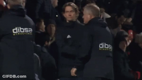 A Man Wearing A Black Jacket With The Word Adidas On It GIF