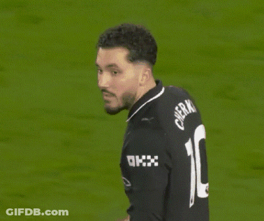 A Man Wearing A Black Jersey With The Number 10 On The Back GIF
