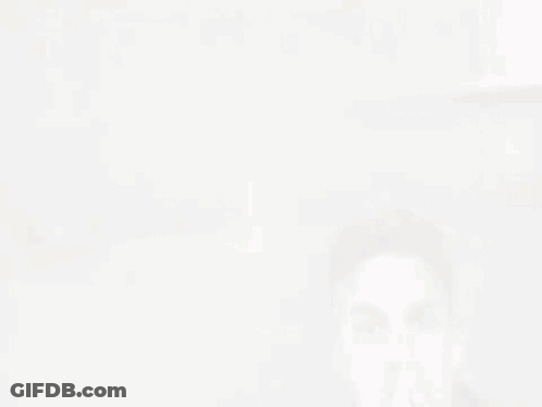 A Man Wearing A Black Leather Jacket Is Covering His Mouth GIF