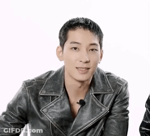 A Man Wearing A Black Leather Jacket Is Smiling GIF