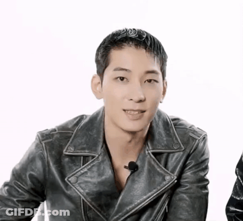 A Man Wearing A Black Leather Jacket Is Smiling GIF