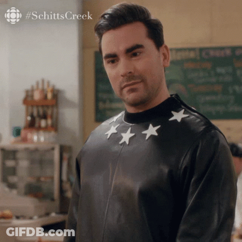 A Man Wearing A Black Leather Jacket With White Stars On The Sleeves GIF