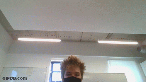 Man In Black Mask Standing In Front Of Whiteboard GIF