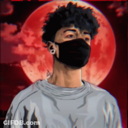 A Man Wearing A Black Mask Stands In Front Of A Red Moon GIF