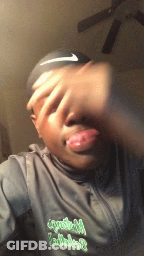 A Man Wearing A Black Nike Headband Covering His Face With His Hands GIF