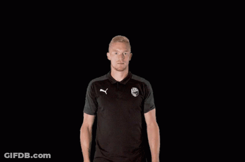 A Man Wearing A Black Polo Shirt With A Puma Logo On It GIF