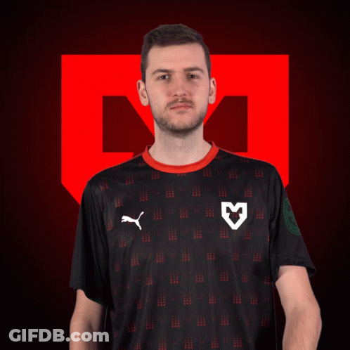 A Man Wearing A Black Puma Shirt With A White Heart On The Front GIF