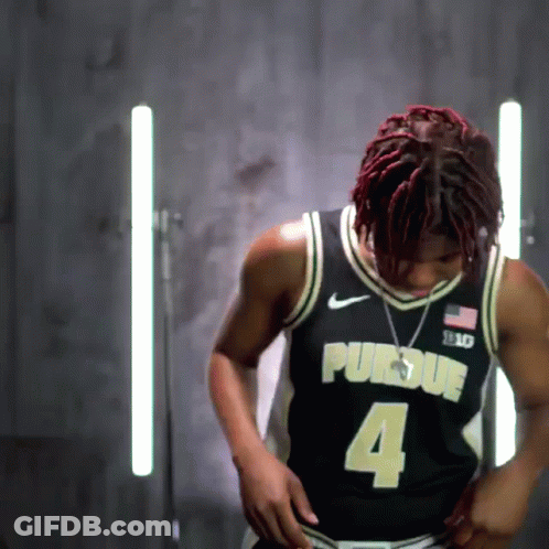 A Man Wearing A Black Purdue Jersey With The Number 4 GIF