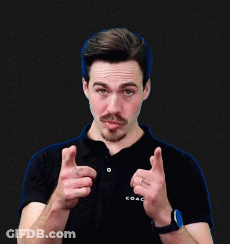 A Man Wearing A Black Shirt And A Watch Giving A Thumbs Up GIF