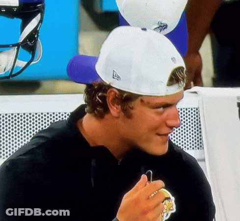 A Man Wearing A Black Shirt And A White Hat With The Letter A On It GIF