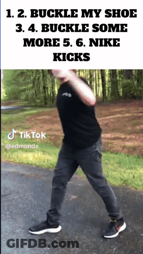 A Man Wearing A Black Shirt And Gray Pants Is Walking Down A Street With A Tiktok Watermark GIF