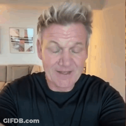 A Man Wearing A Black Shirt Is Making A Funny Face With His Eyes Closed GIF