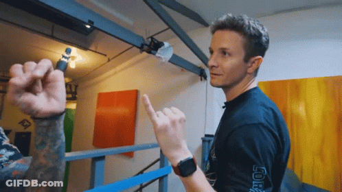 A Man Wearing A Black Shirt That Has The Word Joker On The Sleeve GIF