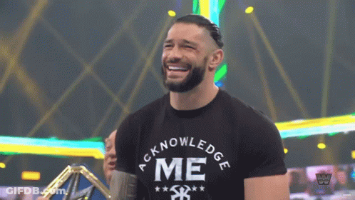 A Man Wearing A Black Shirt That Says Acknowledge Me On It GIF