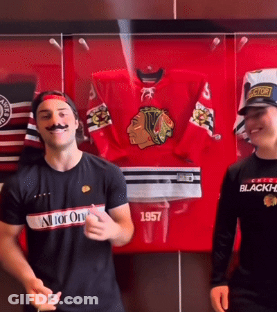 A Man Wearing A Black Shirt That Says All For One Is Standing Next To Another Man GIF