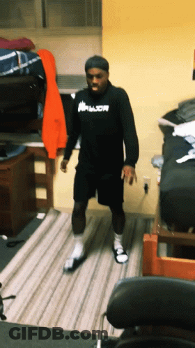 A Man Wearing A Black Shirt That Says Armor GIF